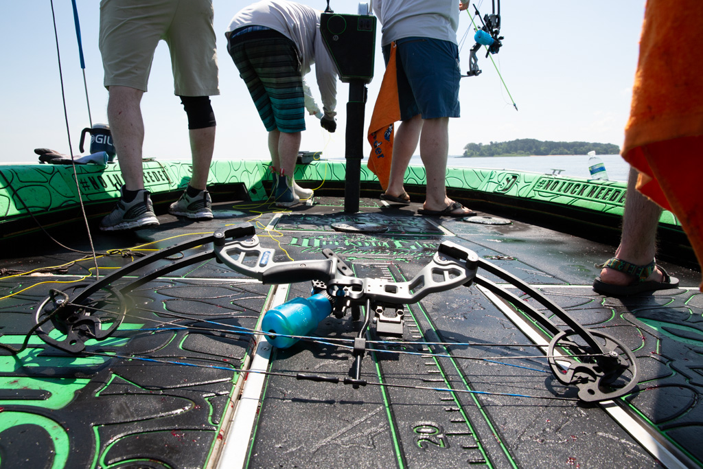 Bowfishing bow laying on the floor of a bowfishing boat